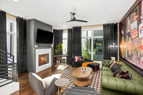 a living room with fireplace furniture and a flat screen tv