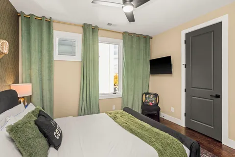 a bedroom with a bed and a chandelier