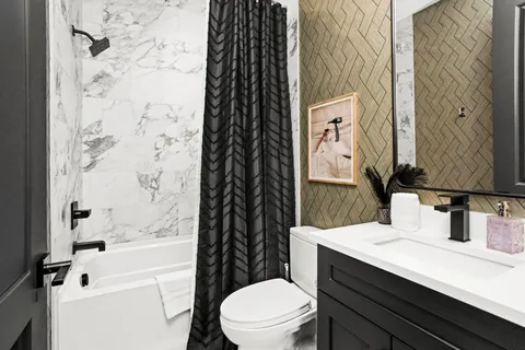 a bathroom with a sink toilet and shower