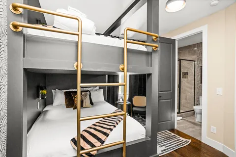 a bedroom with a bed and a flat tv screen on a dresser