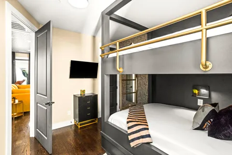 a bathroom with a sink a toilet a mirror and shower