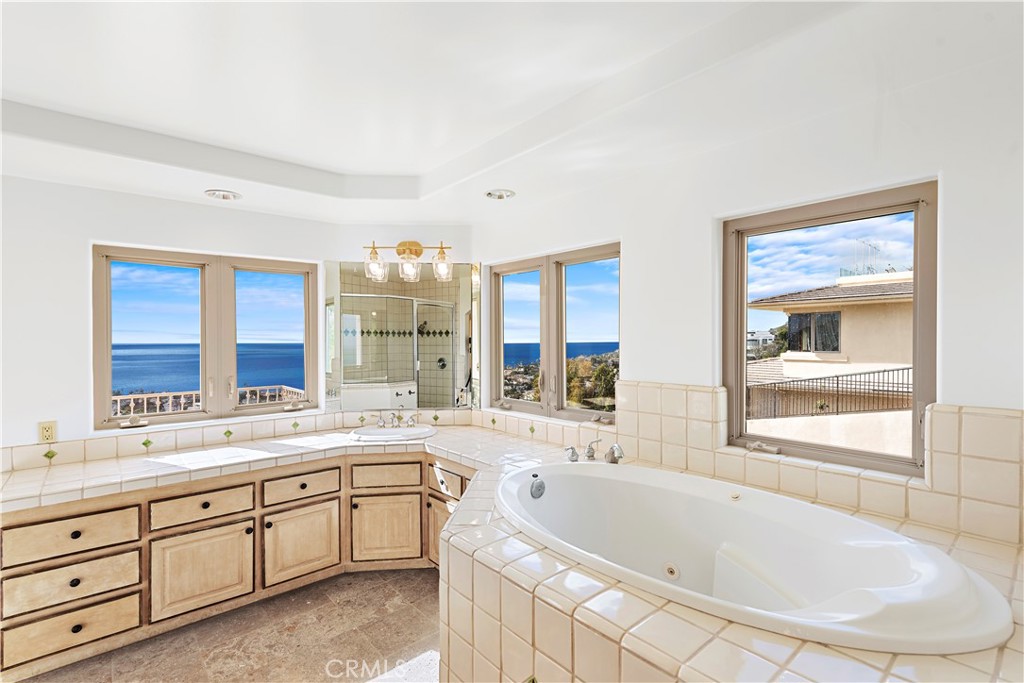 a large bathroom with a large tub sink and window