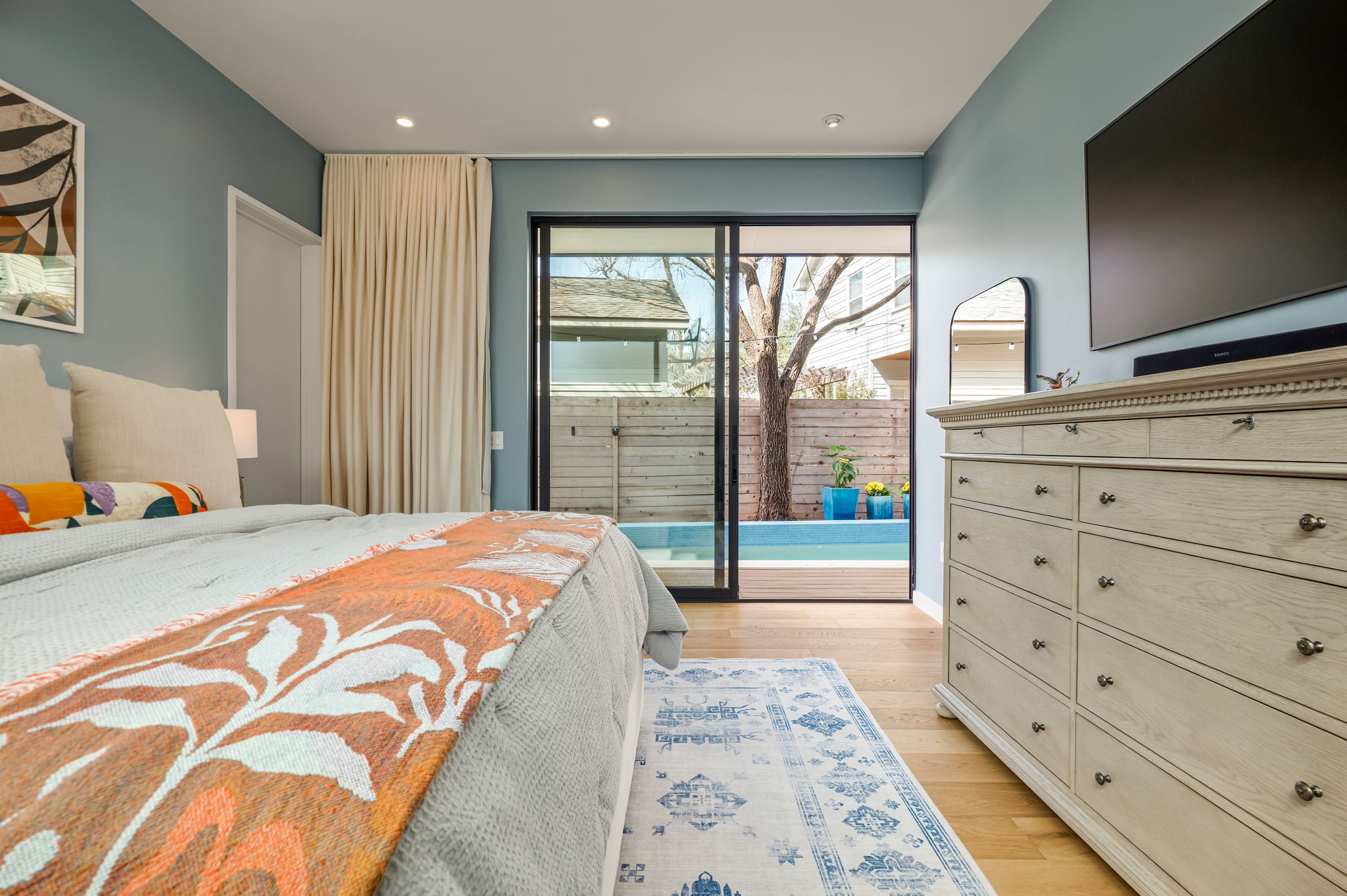 1811 Collier Street Austin, TX 78704 - Photo 16 of 40 Bedroom featuring access to outside, light wood-style floors, and recessed lighting