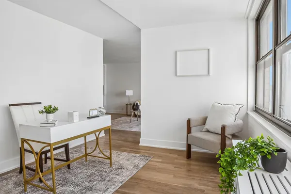 a workspace with furniture and a potted plant