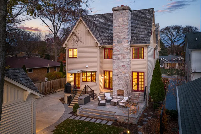 a view of a house with backyard and sitting area
