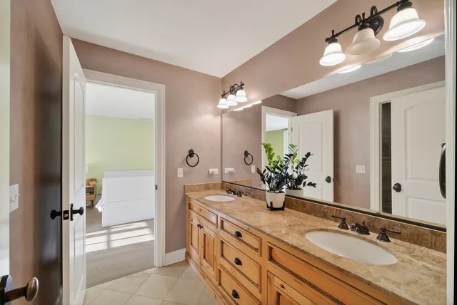 a bedroom with a bed and painting on the wall