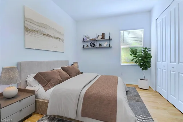 a bedroom with furniture and a potted plant