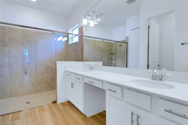 a bathroom with a sink double vanity and shower