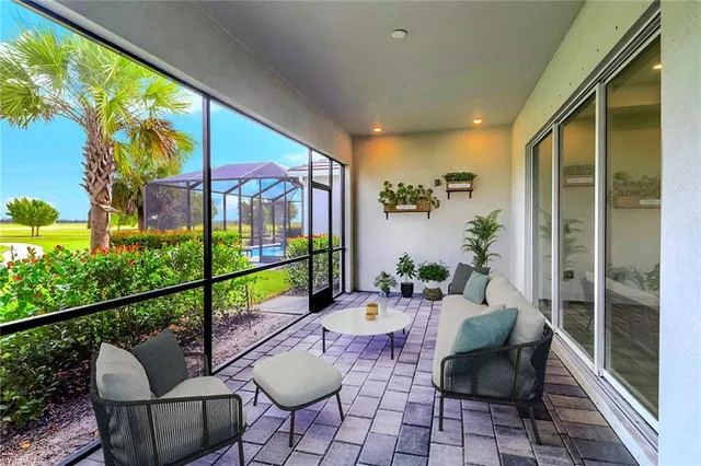 a balcony with chairs and with potted plants