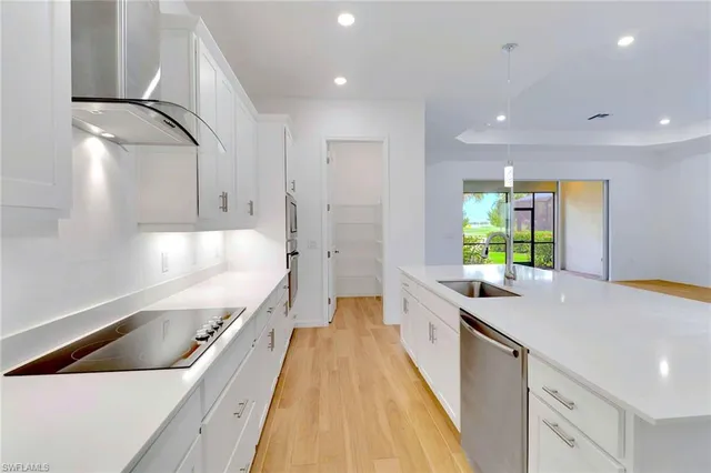 a spacious bathroom with a granite countertop double vanity sink and a bathtub