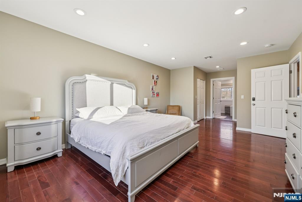 17 Maple Avenue Mahwah, NJ 07430 - Photo 20 of 36 a large bedroom with a bed and wooden floor