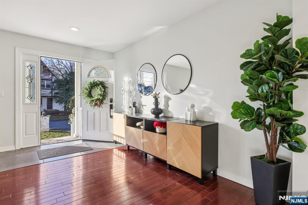 17 Maple Avenue Mahwah, NJ 07430 - Photo 2 of 36 a living room with furniture a potted plant and a wooden floor