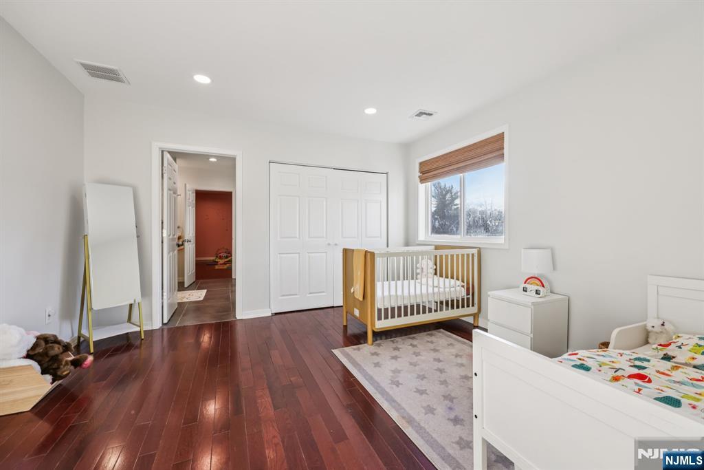 17 Maple Avenue Mahwah, NJ 07430 - Photo 24 of 36 a bedroom with a bed and wooden floor
