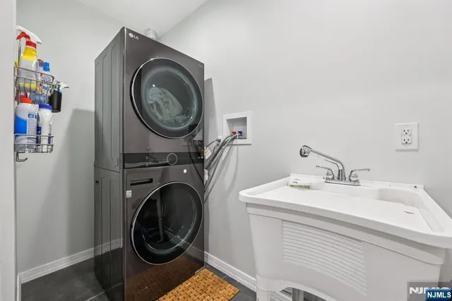 a utility room with sink dryer and washer