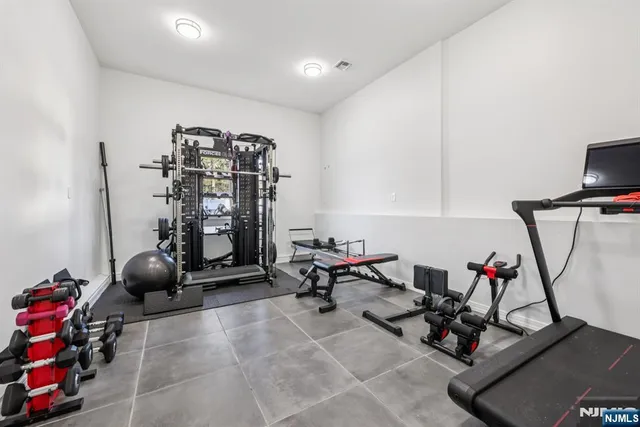 a room with gym equipment and air hockey table