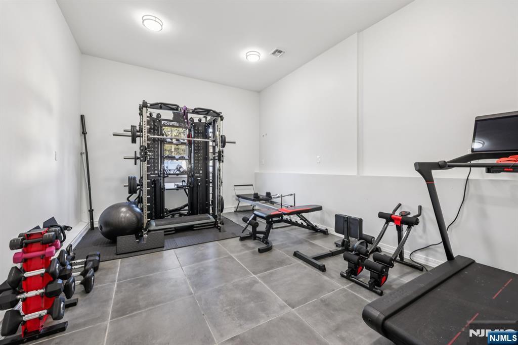 17 Maple Avenue Mahwah, NJ 07430 - Photo 30 of 36 a room with gym equipment and air hockey table