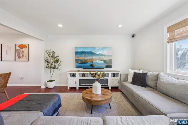 a living room with furniture and a painting