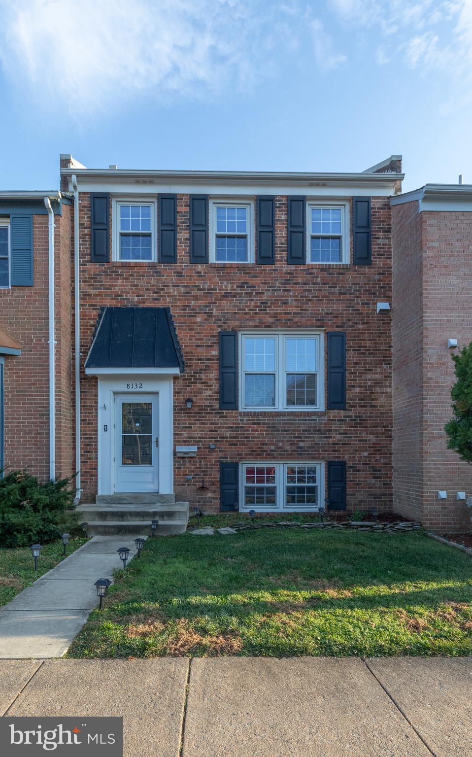 a brick building with a yard