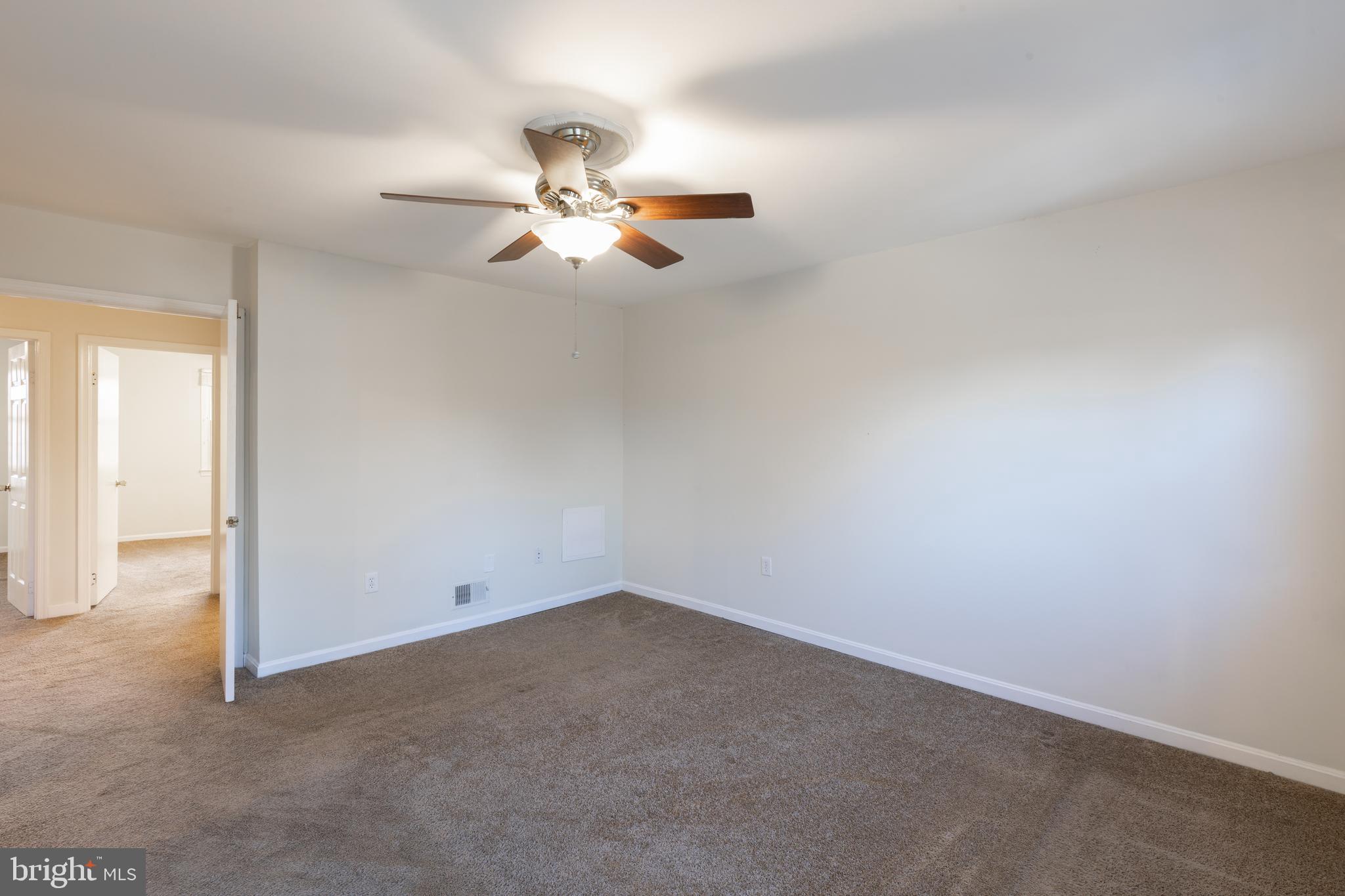 8132 Sleepy View Lane Springfield, VA 22153 - Photo 12 of 31 an empty room with a ceiling fan and window
