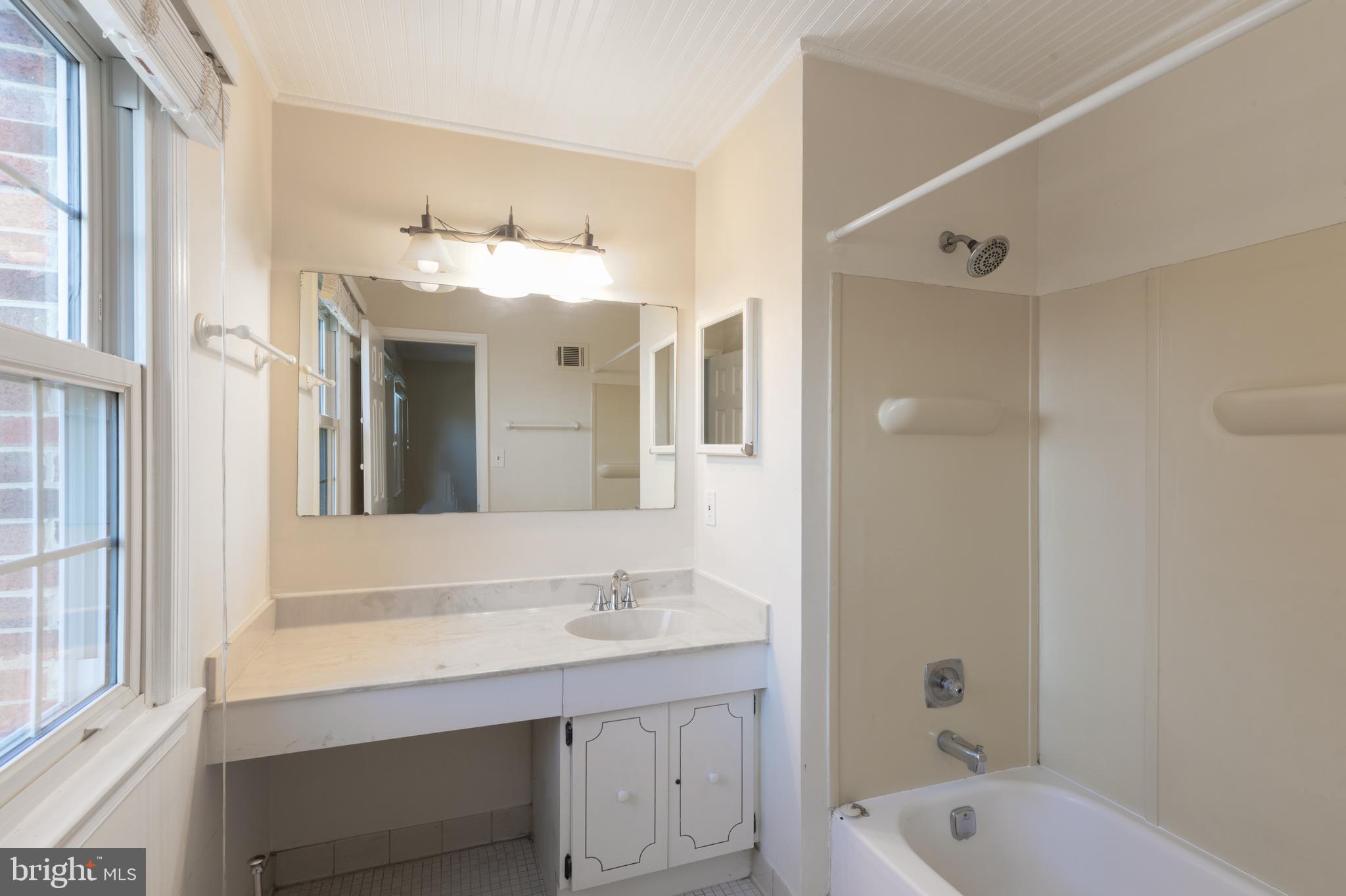 8132 Sleepy View Lane Springfield, VA 22153 - Photo 13 of 31 a bathroom with a tub sink and mirror