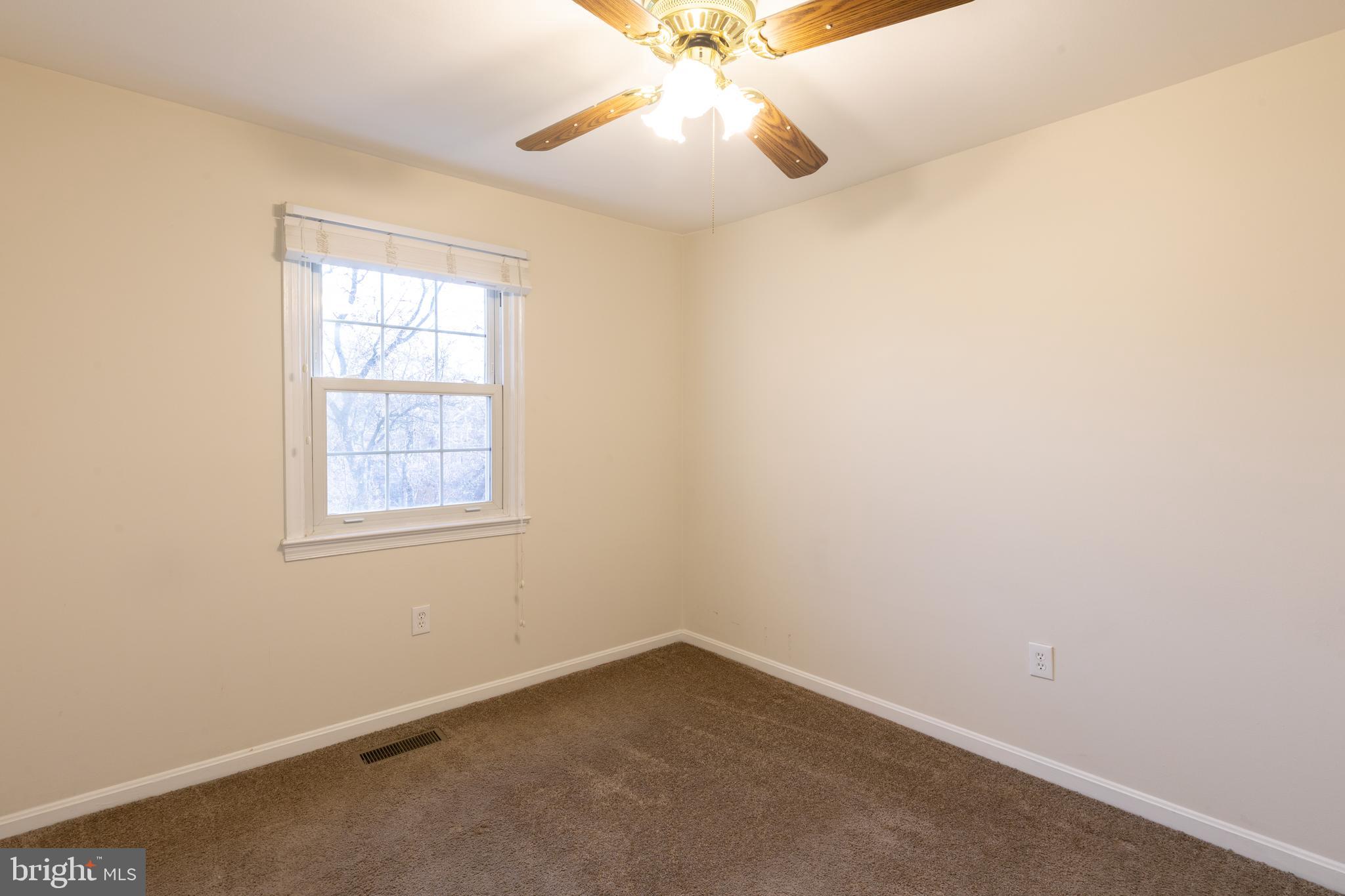 8132 Sleepy View Lane Springfield, VA 22153 - Photo 15 of 31 an empty room with a window and a fan