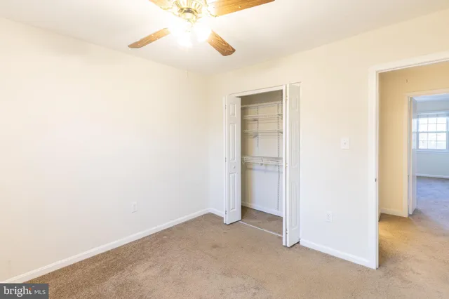 an empty room with a empty space and a ceiling fan