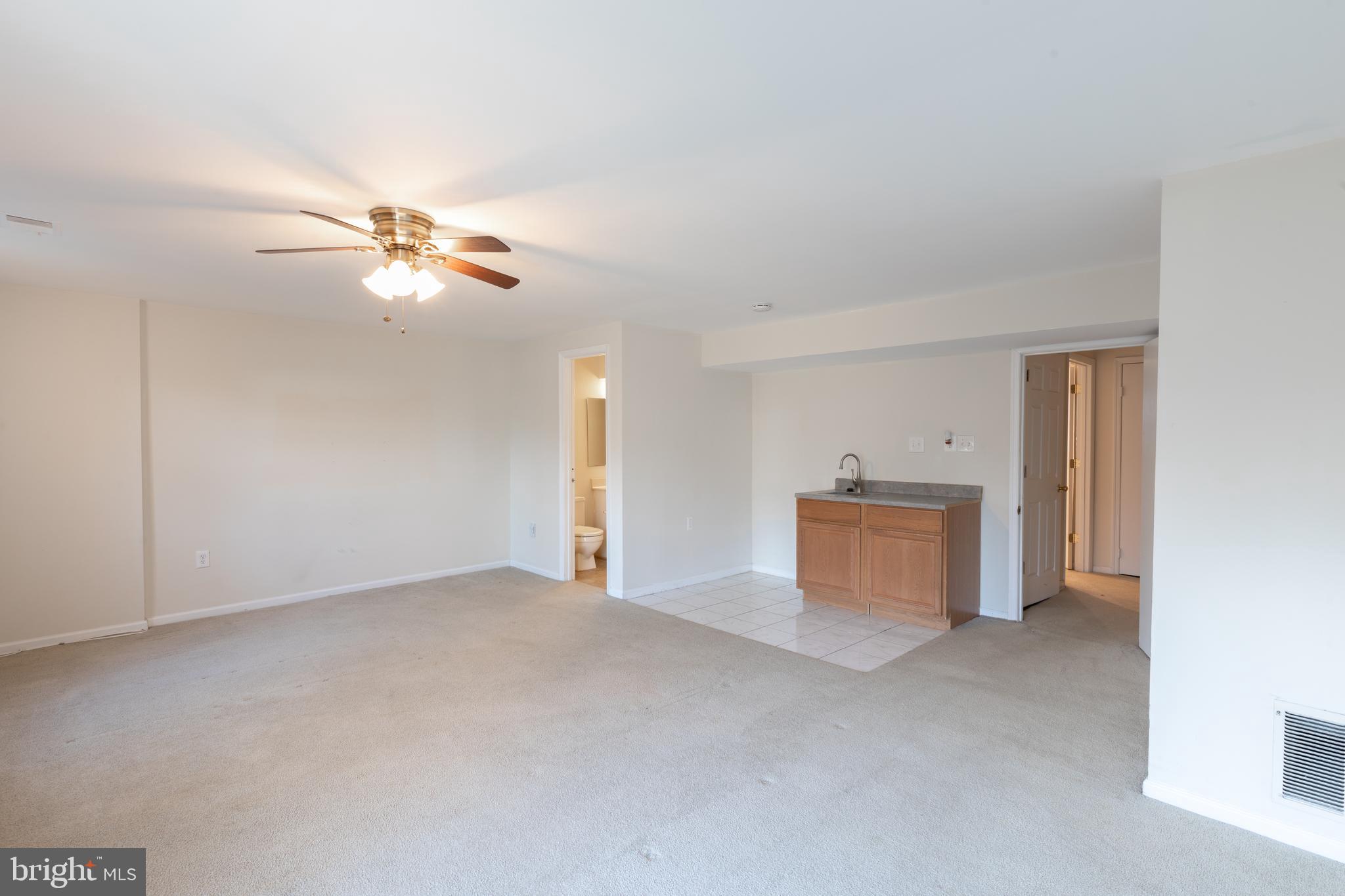 8132 Sleepy View Lane Springfield, VA 22153 - Photo 22 of 31 a view of an empty room with a chandelier fan