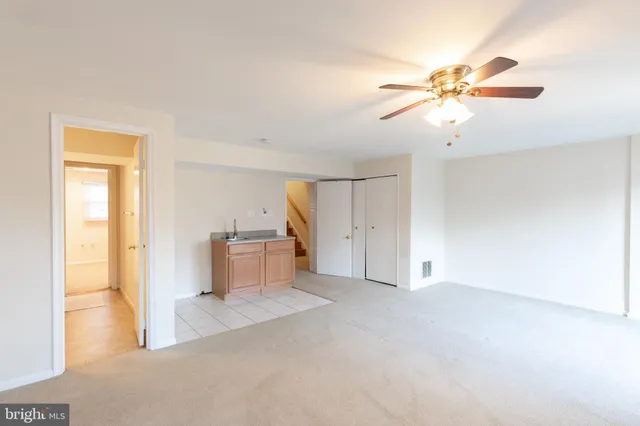 a view of a room with chandelier fan and windows
