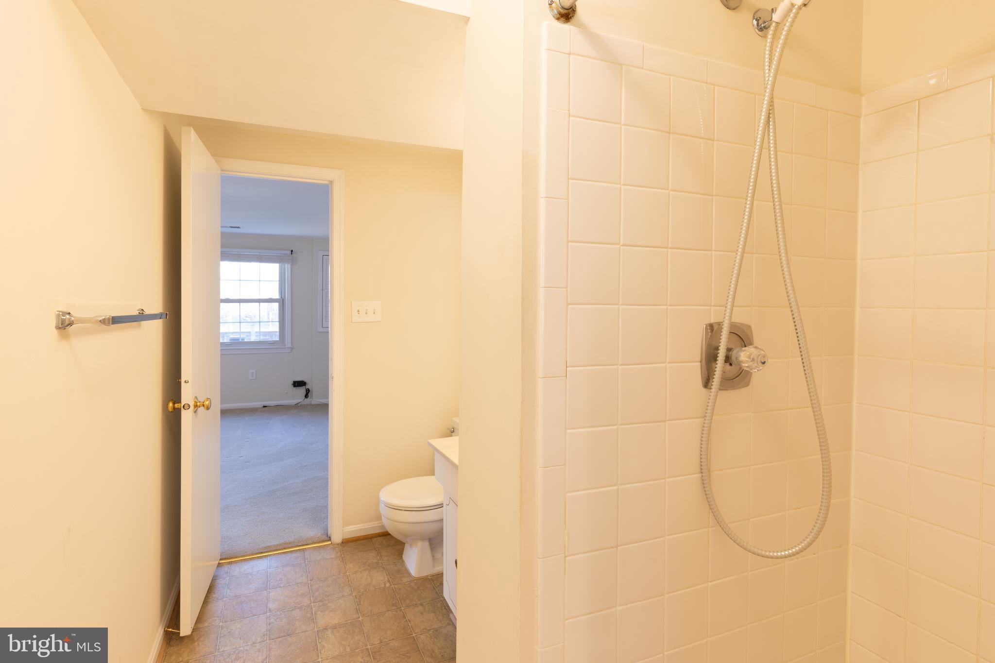 8132 Sleepy View Lane Springfield, VA 22153 - Photo 25 of 31 a bathroom with a granite countertop shower a toilet and a sink
