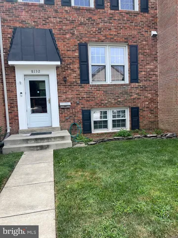 a view of a brick house with a yard