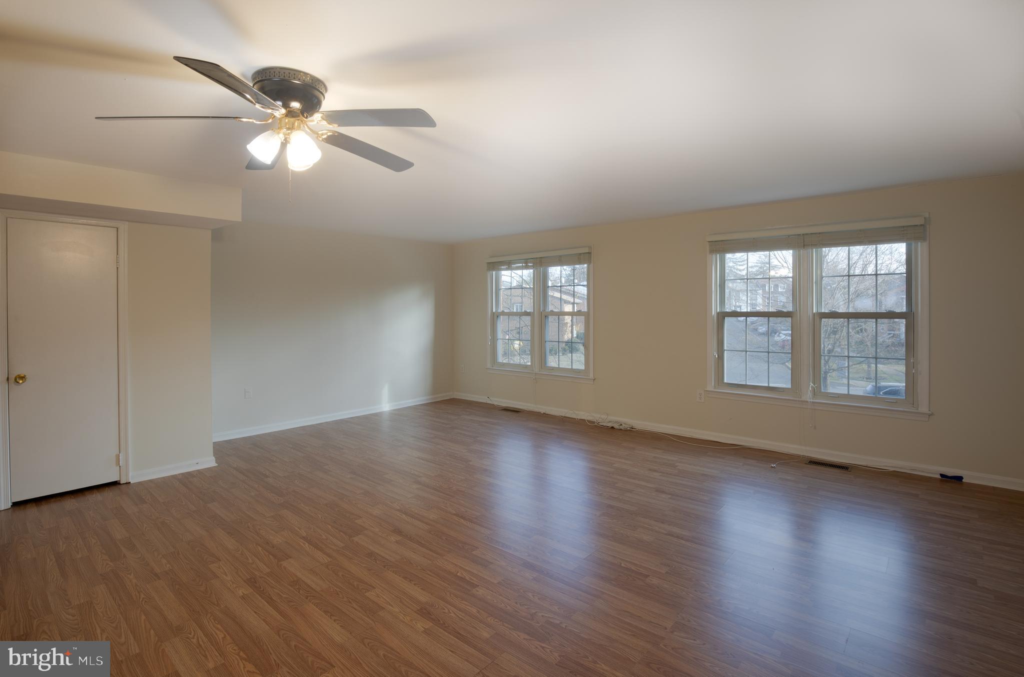 8132 Sleepy View Lane Springfield, VA 22153 - Photo 6 of 31 a view of an empty room with wooden floor and a window
