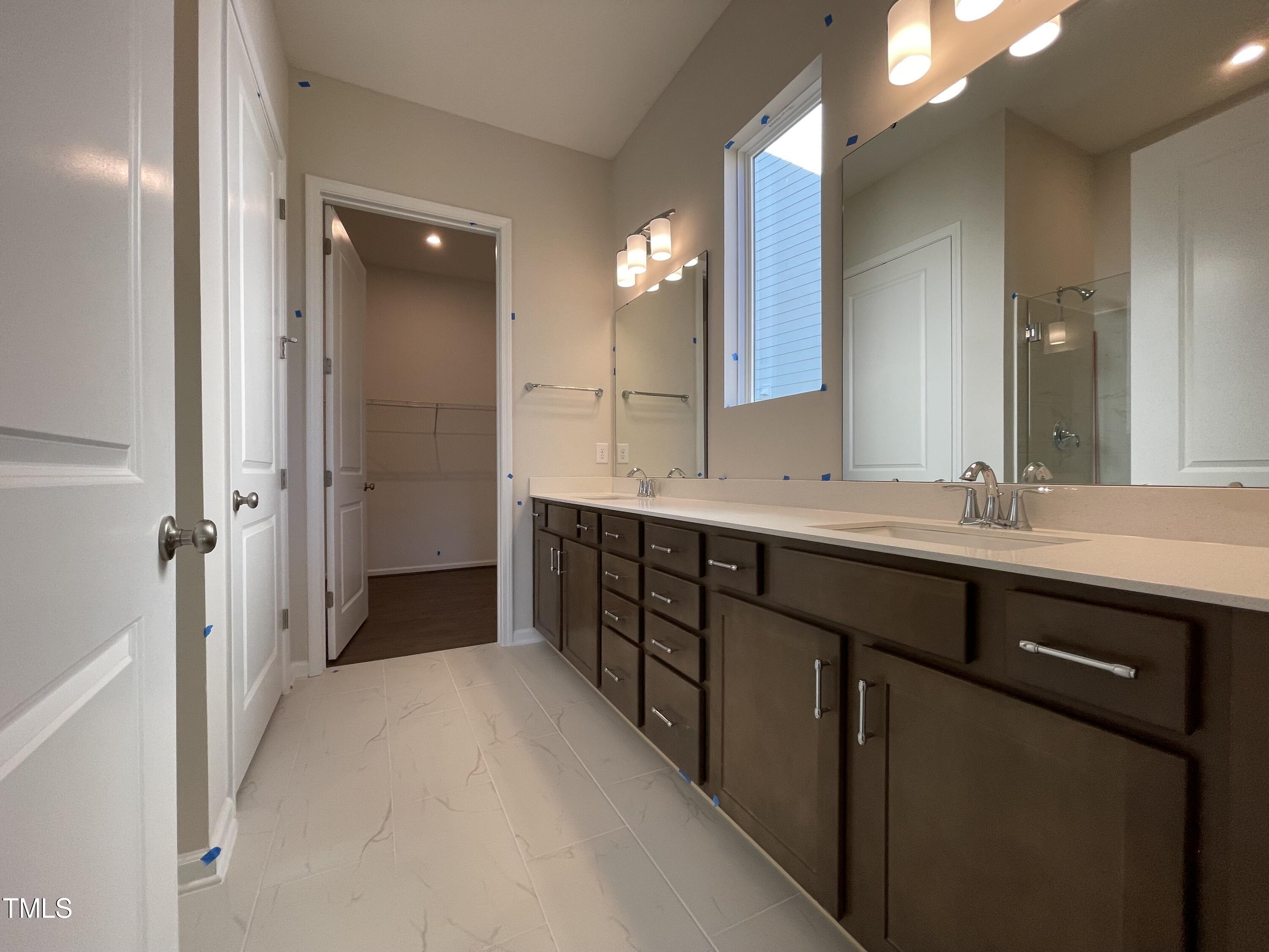548 Marthas View Way Wake Forest, NC 27587 - Photo 23 of 44 a spacious bathroom with a double vanity sink a mirror and a shower