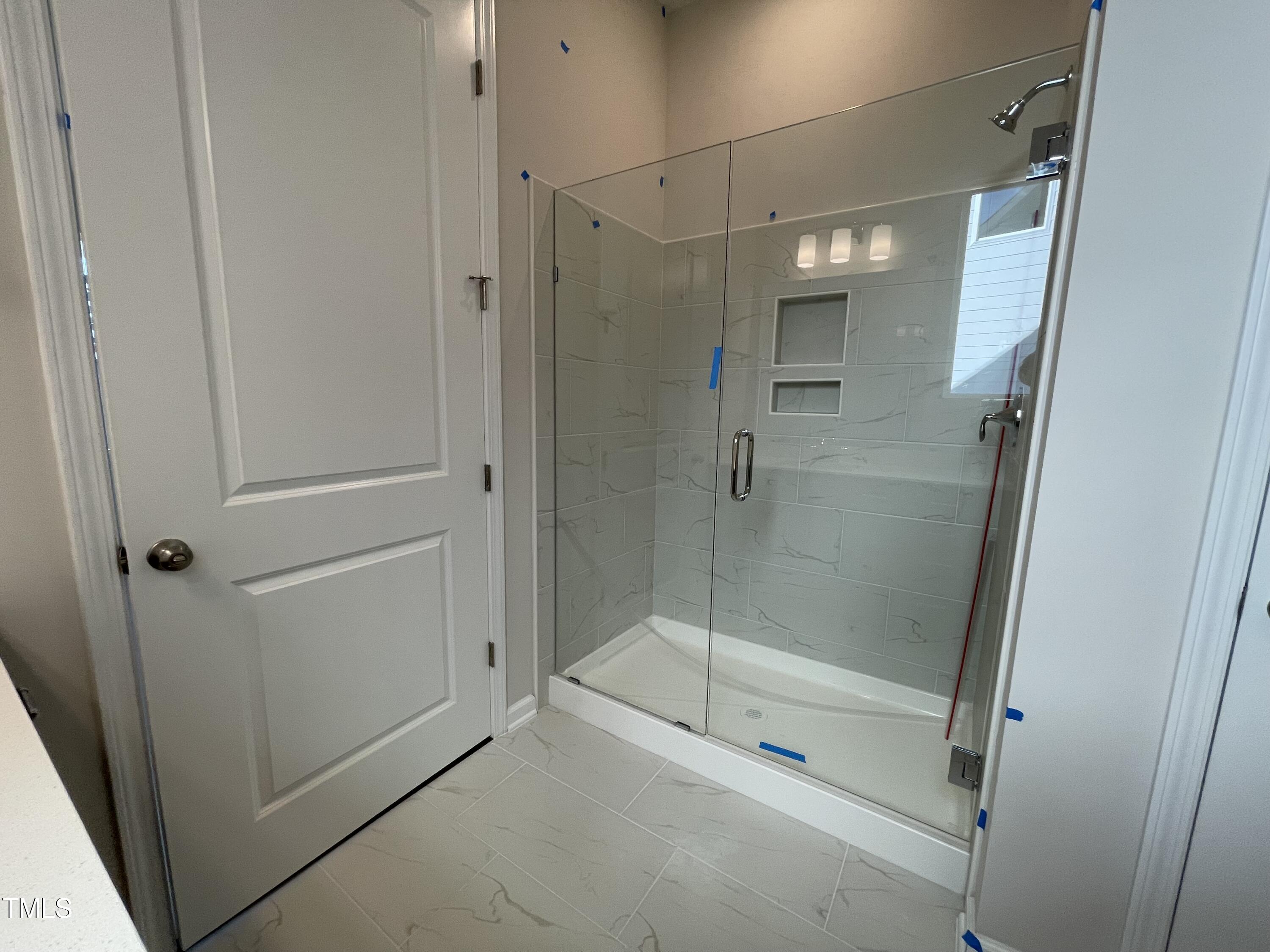 548 Marthas View Way Wake Forest, NC 27587 - Photo 24 of 44 a bathroom with a glass shower door