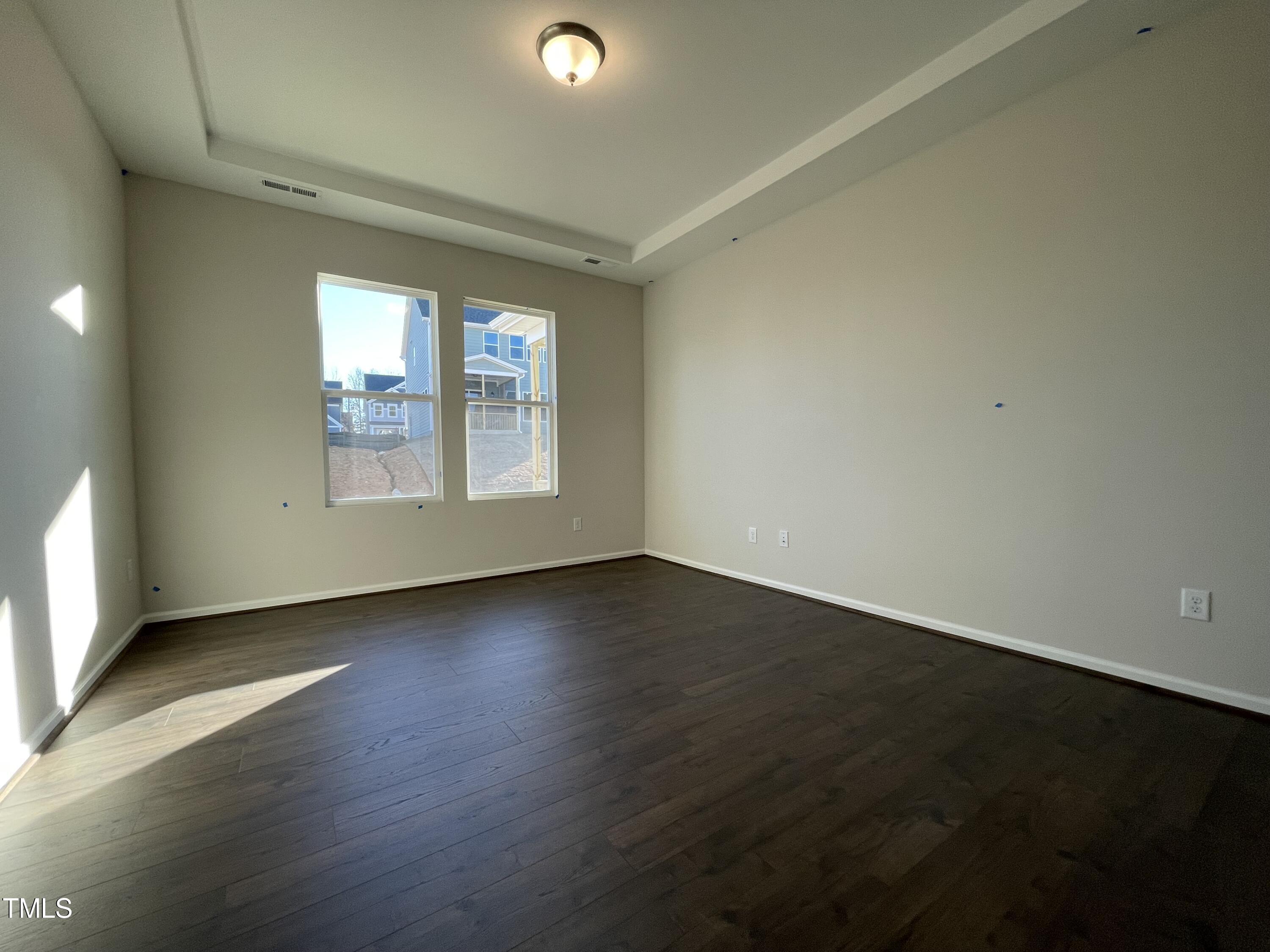 548 Marthas View Way Wake Forest, NC 27587 - Photo 27 of 44 an empty room with wooden floor and windows