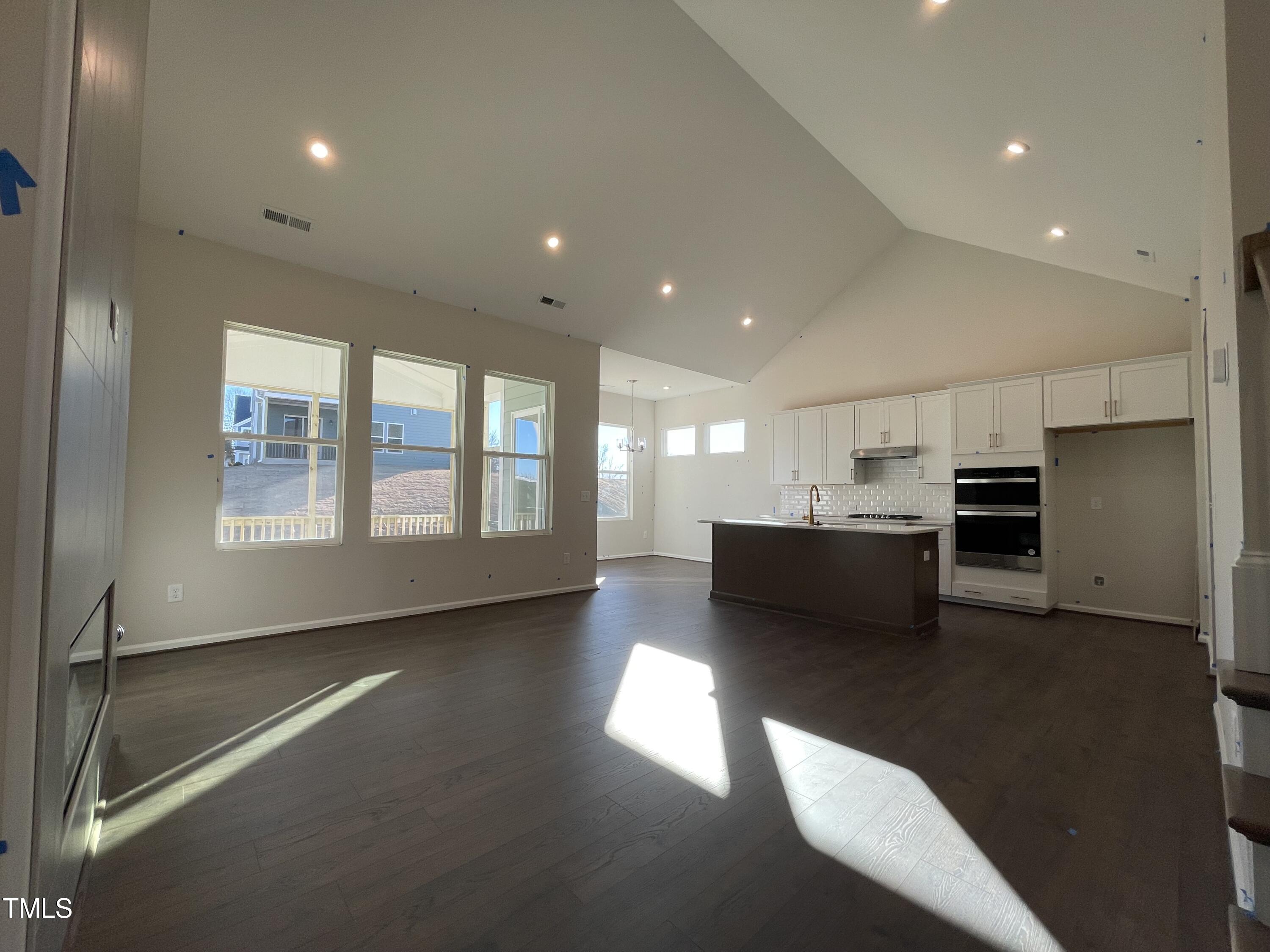 548 Marthas View Way Wake Forest, NC 27587 - Photo 9 of 44 a view of large kitchen with kitchen island a sink wooden floor and a large window