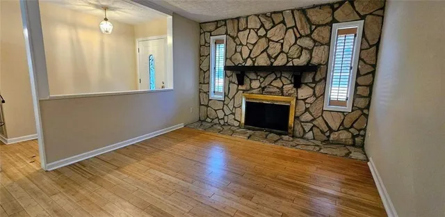 a view of an empty room and wooden floor