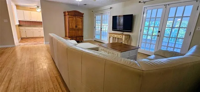 a living room with furniture and a flat screen tv