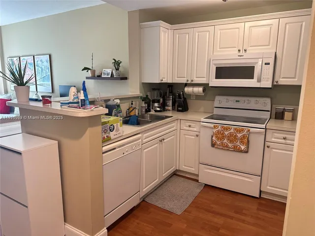 a kitchen with a stove and white cabinets