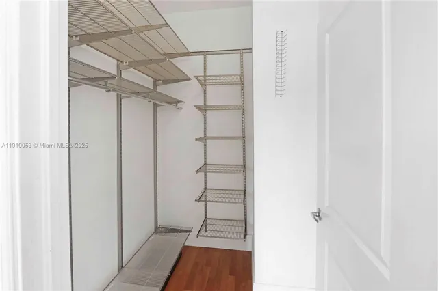 a view of walk in closet with empty racks
