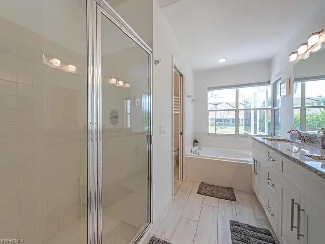 a bathroom with a bathtub and a shower