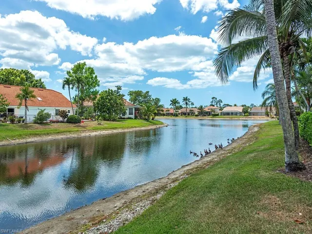 a view of a lake with houses in the background