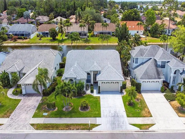 an aerial view of a house with swimming pool outdoor seating and yard