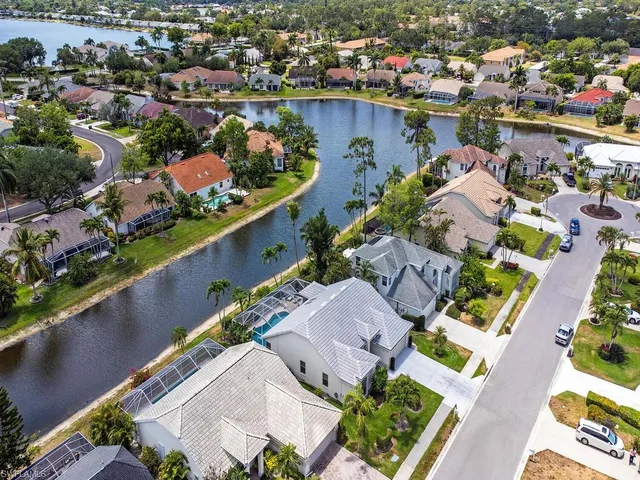 an aerial view of lake and residential houses with outdoor space