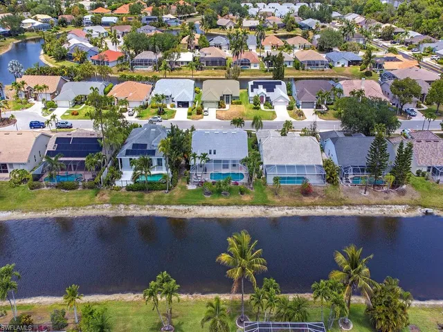 an aerial view of residential houses with outdoor space and swimming pool