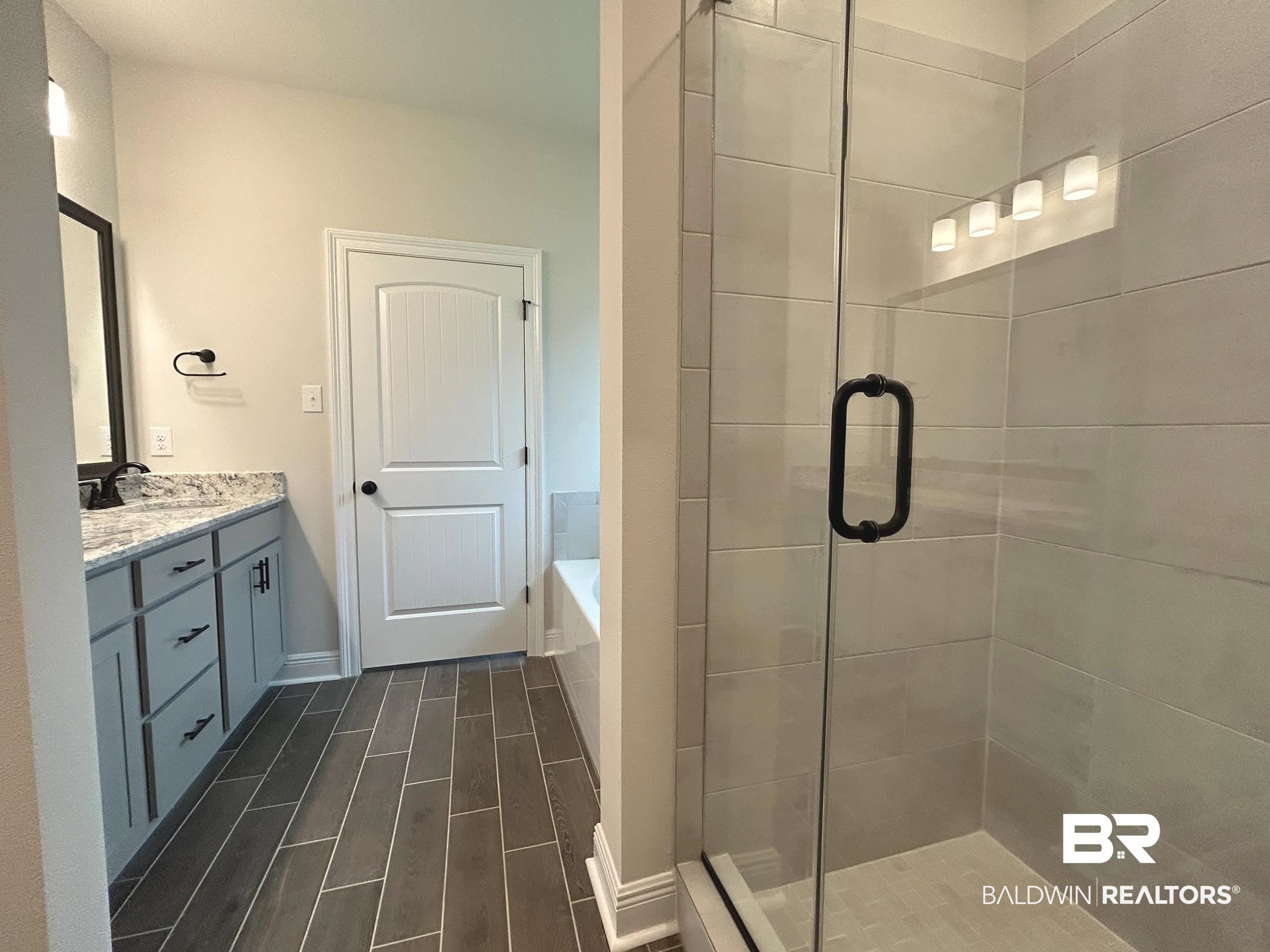 844 Sumter Loop Foley, AL 36535 - Photo 9 of 18 Bathroom featuring vanity and separate shower and tub