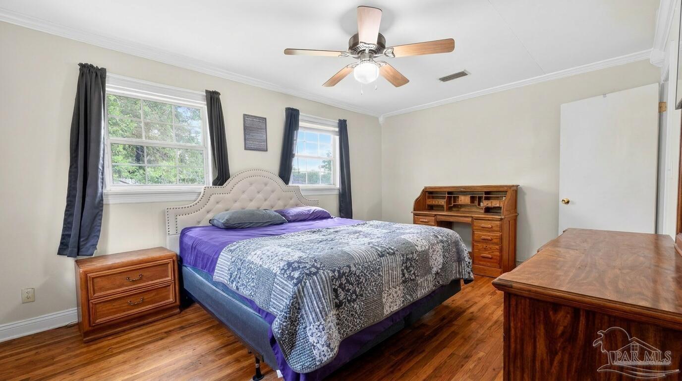 6253 Allentown Road Milton, FL 32570 - Photo 22 of 31 a bedroom with a bed dresser and a window