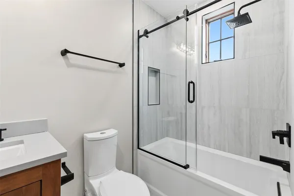 a bathroom with a shower a toilet and a sink