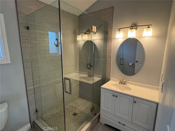 a bathroom with a sink mirror and toilet