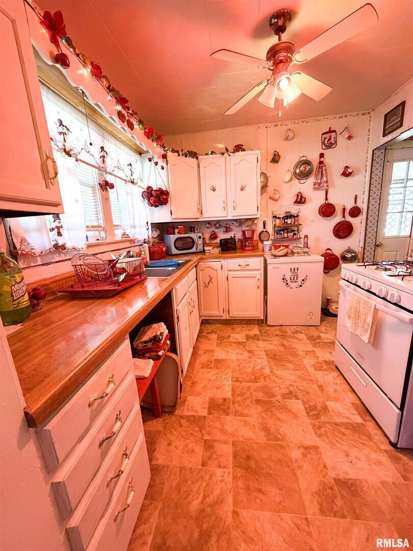 601 East Lafayette Street Olney, IL 62450 - Photo 11 of 45 a kitchen with stainless steel appliances kitchen island granite countertop a sink and cabinets