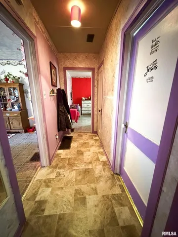 a bedroom with a bed mirror and window